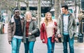 Multiracial group of millenial friends walking at London city center - Next generation friendship concept on multicultural young