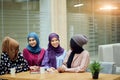 Multiracial group of muslim women dressed in national clothes posing in group