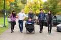 Multiracial group walking at park with child in wheelchair Royalty Free Stock Photo