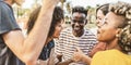 Multiracial group of young people having fun together on city street - Happy lifestyle concept with guys and girls hanging outside Royalty Free Stock Photo