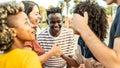 Multiracial group of young people having fun together on city street - Happy lifestyle concept with guys and girls hanging outside Royalty Free Stock Photo