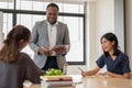 Multiracial group of young students studying English with an African American teacher Royalty Free Stock Photo