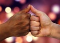 Multiracial hands together African American and Caucasian touching thumbs as team in promise sign of mutual trust representing