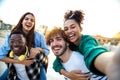 Multiracial happy friends having fun taking group selfie portrait on city street. Diverse people laugh together outdoors Royalty Free Stock Photo