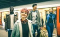 Multiracial hipster friends group walking at tube subway station Royalty Free Stock Photo