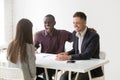 Multiracial hr managers laughing at funny joke interviewing woma