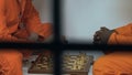 Multiracial male cellmates playing chess in spare time, prison entertainments