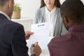 HR managers reading female employee resume in office Royalty Free Stock Photo