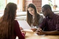 Multiracial managers reading applicant resume during hiring Royalty Free Stock Photo