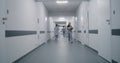 Multiracial medical staff walk clinic corridor Royalty Free Stock Photo