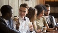 Multiracial men talking drinking coffee hanging with friends usi Royalty Free Stock Photo