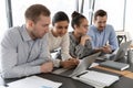 Multiracial millennial employees involved in project development, working in groups. Royalty Free Stock Photo