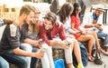 Multiracial millennials group using smart phone at city college Royalty Free Stock Photo