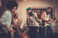 Multiracial music band in a studio Royalty Free Stock Photo