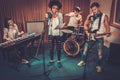 Multiracial music band in a studio