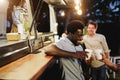 Multiracial people cheering with drinks in counter at food truck restaurant outdoor - Focus on african american man face