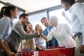 Multiracial people having fun in office room, excited diverse employees enjoying activity at work Royalty Free Stock Photo