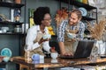 Multiracial people working on laptop during inventory