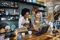 Multiracial people working on laptop during inventory