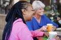 Multiracial senior friends meet and chat at bar outdoor while drinking coffee together Royalty Free Stock Photo