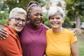 Multiracial senior women having fun together after sport workout outdoor - Focus on left female face