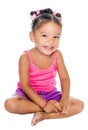 Multiracial small girl laughing sitting on the floor