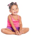 Multiracial small girl laughing sitting on the floor