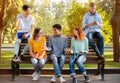 Multiracial Students Relaxing After Classes Sitting On Bench In Park Royalty Free Stock Photo