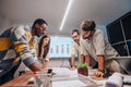 Multiracial Team of Architects and Engineers Collaborating on Innovative Project in Board Room Royalty Free Stock Photo