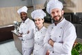 Multiracial team of cooks looking at camera Royalty Free Stock Photo