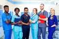 Multiracial team of young doctors in a hospital standing in a operating room