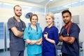 Multiracial team of young doctors in a hospital standing in a operating room