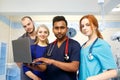 Multiracial team of young doctors working on laptop computer in medical office. Royalty Free Stock Photo