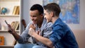 Multiracial teenagers winning money in gambling game bets on sport adult content