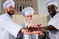 Multiracial tram of cooks stacking hands together Royalty Free Stock Photo