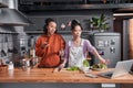 Females discussing recipes while preparing dinner at kitchen Royalty Free Stock Photo