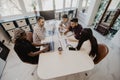 Multiracial young creative people in modern office. Group of young business people are working together with laptop, tablet, smart Royalty Free Stock Photo