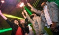 Multiracial young friends dancing at night club with sparkler fireworks - Happy people having crazy fun at nightclub after party Royalty Free Stock Photo