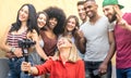 Multiracial young friends taking selfie with mobile smart phone and stabilizer gimbal - Friendship concept with millenial people Royalty Free Stock Photo