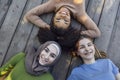 Multiracial young teen female friends resting in the park after sport training laughing and having fun together Royalty Free Stock Photo