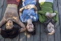 Multiracial young teen female friends resting in the park after sport training laughing and having fun together Royalty Free Stock Photo