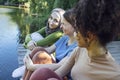 Multiracial young teen female friends resting in the park after sport training laughing and having fun together Royalty Free Stock Photo