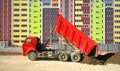 Multistorey building apartment house and dump truck unload soil