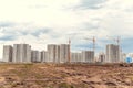 Multistorey building and big cranes