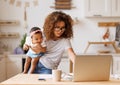 Multitasking african american self-employed mother working with baby from home on maternity leave Royalty Free Stock Photo