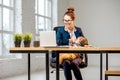 Multitasking businesswoman with her son working at the office Royalty Free Stock Photo