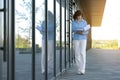 Multitasking busy young business woman during walks reading and dropping important finance documents by the office Royalty Free Stock Photo