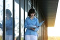 Multitasking busy young business woman during walks reading and dropping important finance documents by the office Royalty Free Stock Photo