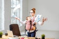 Businesswoman with her baby son working with documents at the office Royalty Free Stock Photo