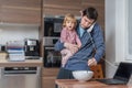 Multitasking father is babysitting and working at home Royalty Free Stock Photo